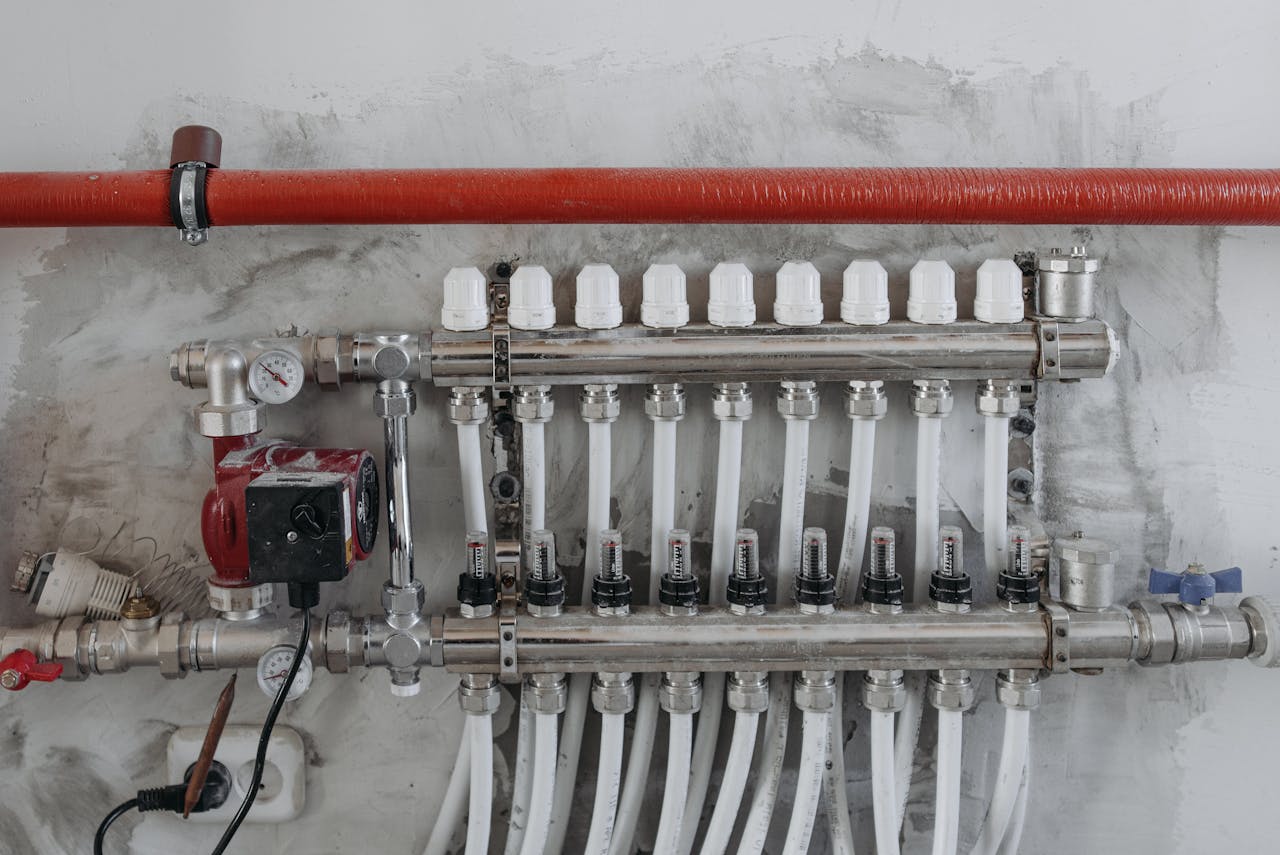 services-04 A close-up view of an industrial manifold with pressure gauges and connected steel pipes.